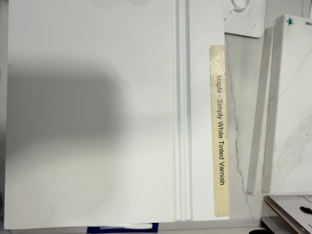 StarMark Cabinetry — Maple, Simply White Tinted Varnish (door + edge detail)